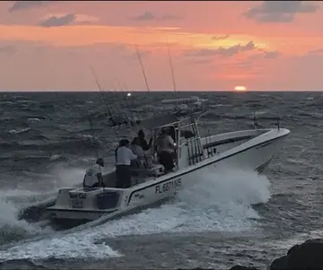 Center console boat cruising at dusk off Jupiter