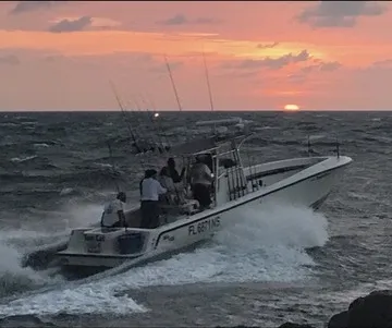 Center console boat cruising at dusk off Jupiter