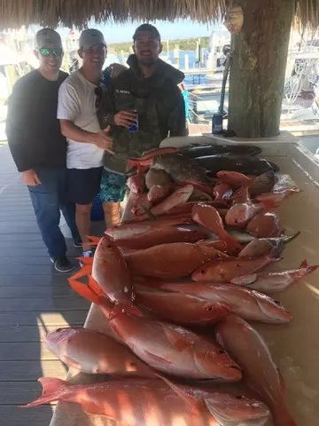 Table at the marina piled high with snapper after a reef trip